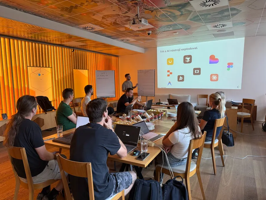 A CX Academy masterclass with participants at laptops and a talk on the screen